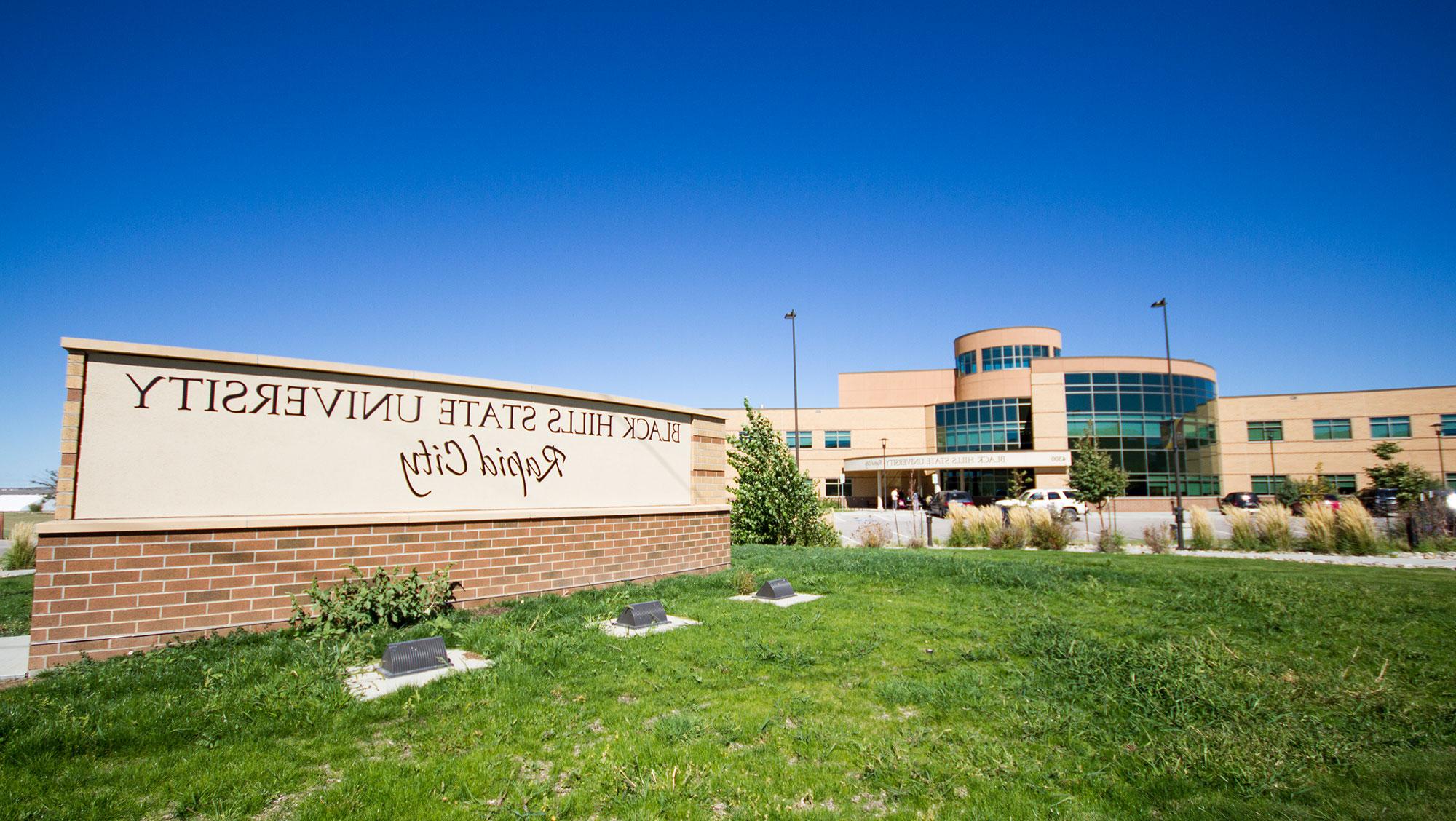 Image of BHSU-RC campus with green grass and sign.